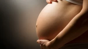 Close up of pregnant belly representing a healthy pregnancy for surrogacy